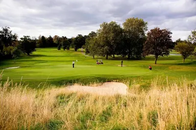 a group of people playing golf on a golf course at Hanbury Manor Marriott Hotel & Country Club in Ware