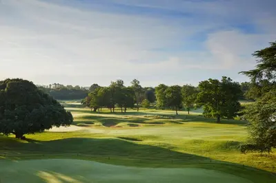 a view of a golf course with a green at Hanbury Manor Marriott Hotel & Country Club in Ware