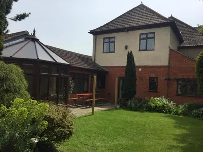 a house with a picnic table in the yard at Toothbrush Rooms at Lattice Lodge - Guest Kitchen & EV Recharging in Ipswich