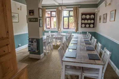 a room with a long table and chairs at Toothbrush Rooms at Lattice Lodge - Guest Kitchen & EV Recharging in Ipswich
