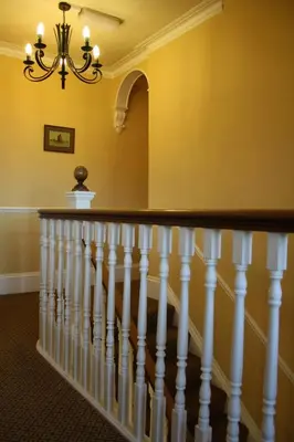 a staircase in a house with a chandelier at Toothbrush Rooms at Lattice Lodge - Guest Kitchen & EV Recharging in Ipswich