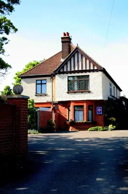 a white house with a chimney on a street at Toothbrush Rooms at Lattice Lodge - Guest Kitchen & EV Recharging in Ipswich