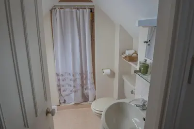 a bathroom with a white toilet and a sink at Toothbrush Rooms at Lattice Lodge - Guest Kitchen & EV Recharging in Ipswich
