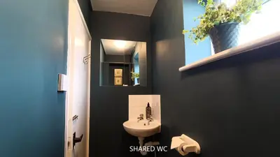 a bathroom with a sink and a mirror at Stansted Lodge Elsenham in Elsenham