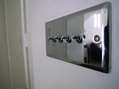 a mirror attached to a wall with a door at Panfield House in Braintree
