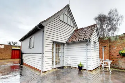 a white house with a pitched roof at Panfield House in Braintree