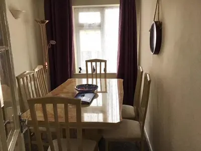a dining room table and chairs with a table and a window at 9 Gunfleet court in Clacton-on-Sea