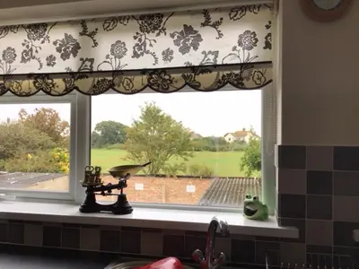 a kitchen window with a floral curtain and a sink at 9 Gunfleet court in Clacton-on-Sea
