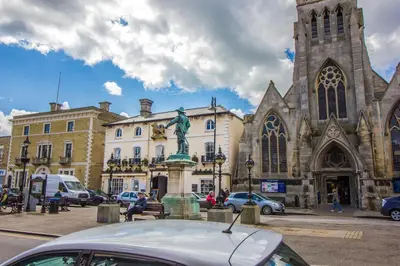 a car parked in front of a church with a statue at The Golden Lion Hotel, St Ives, Cambridgeshire - The Coaching Inn Group in St Ives