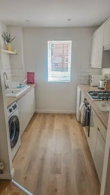 a kitchen with a washer and a washing machine at Welcome Home in Royston