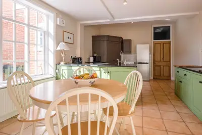 a kitchen with a table with a bowl of fruit on it at Hillcrest, Aldeburgh in Aldeburgh