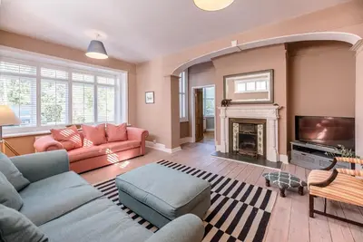 a living room with a couch and a fireplace at Hillcrest, Aldeburgh in Aldeburgh