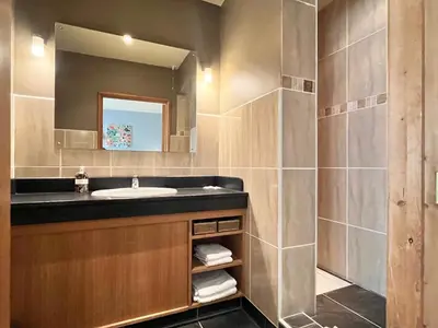a bathroom with a sink and a mirror at Orchard Cottage in Willingham