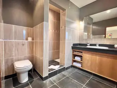 a bathroom with a toilet and a sink at Orchard Cottage in Willingham