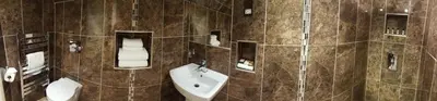 a bathroom with a toilet and a sink at The White Hart in Great Yeldham