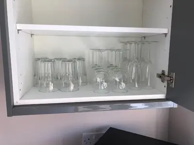 a row of glass vases sitting on a shelf at Guineas House in Newmarket