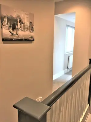 a stairway with a picture on the wall at Guineas House in Newmarket