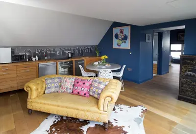 a living room with a couch and a kitchen at Strattons in Swaffham
