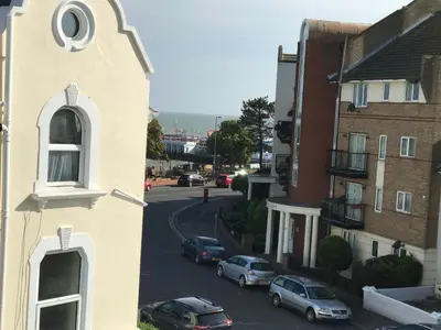 a view of a street with cars parked on the road at Greyfriars in Clacton-on-Sea