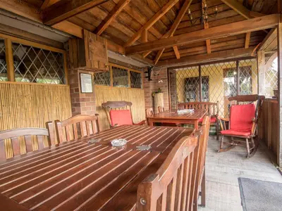 a dining room with a wooden table and chairs at Strenneth in Fersfield