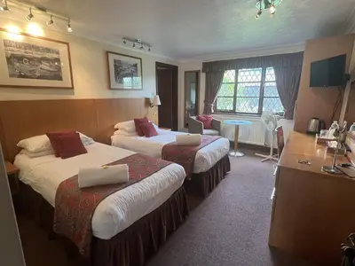 a hotel room with two beds and a desk at Strenneth in Fersfield