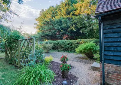 a garden with some plants and a fence at Highgate Annexe in Takeley