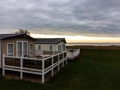 a house with a large porch and a deck at Mersea Island by Away Resorts in Colchester