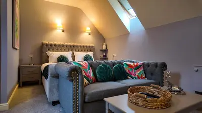 a living room with a couch and a table at The Pheasant Public House & Hotel in Gestingthorpe