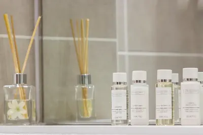 a group of bottles of moisturizers sitting on a shelf at Citystay Living - Midsummer Mews in Cambridge