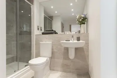 a bathroom with a toilet and a sink and a shower at Citystay Living - Midsummer Mews in Cambridge