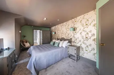 a bedroom with a bed and a wall at The Cricketers Clavering in Clavering
