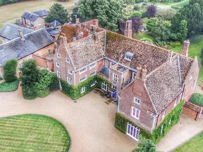 an aerial view of a large house with a yard at Hockwold Hall in Hockwold cum Wilton