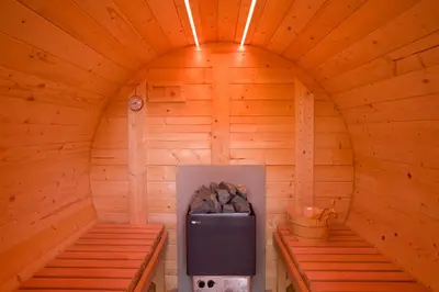 an inside of a wooden cabin with a refrigerator in it at Oak Cottage in Thorndon