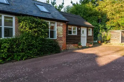 a brick house with a driveway in front of it at Bluebell Studio in Saxmundham