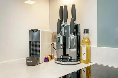 a kitchen counter with a coffee maker and a bottle of wine at Tailored Stays - Central Cambridge Studios, Free Parking in Cambridge