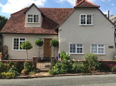 a white house with a brown roof at Corner House Luxury BnB in Little Dunmow