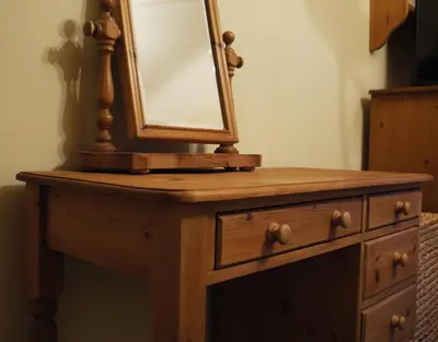 a wooden dresser with a mirror on top of it at One Pelham Grove Bed & Breakfast in Stocking Pelham