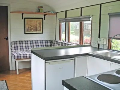 a kitchen with a sink and a couch at Italian Carriage-Ukc3492 in Wetheringsett