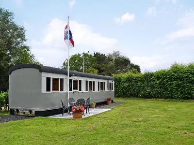 a trailer with a flag on it in a yard at Italian Carriage-Ukc3492 in Wetheringsett