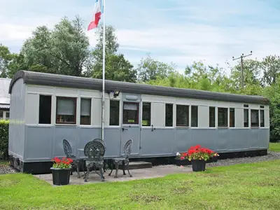 a train car with a flag on top of it at Italian Carriage-Ukc3492 in Wetheringsett