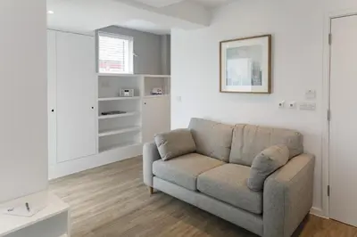 a living room with a couch and a window at Citystay Living - Devonshire Road in Cambridge