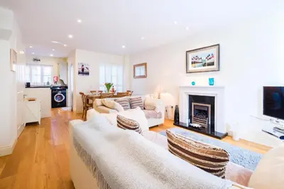 a living room with two couches and a fireplace at Maisie's in Aldeburgh
