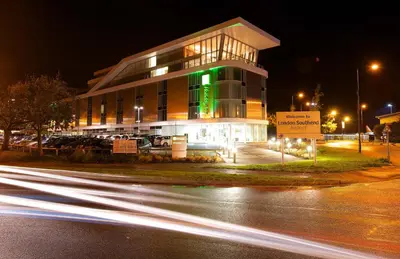a building with a green sign in front of it at Holiday Inn Southend by IHG in Southend-on-Sea