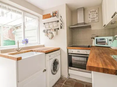 a kitchen with a sink and a washing machine at Ploughman's in Eye