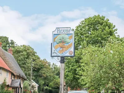 a sign on a pole on a street at Ploughman's in Eye