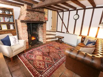 a living room with a couch and a fireplace at Ploughman's in Eye