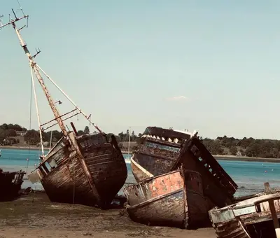 a group of boats sitting on the beach at Kingfisher Nook at Waveney Farm in Hoxne