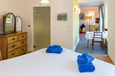 a bedroom with a bed with blue towels on it at Robin's Egg in Aldeburgh