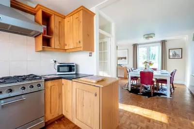 a kitchen with a table and a stove top oven at Briar Hill in Aldringham