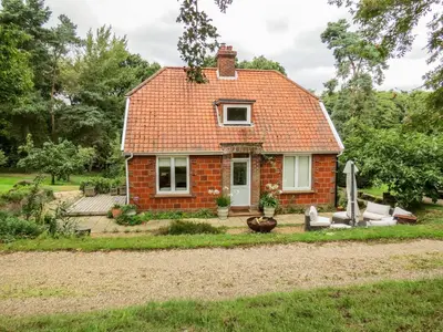 a small red brick house with a yard at Briar Hill in Aldringham